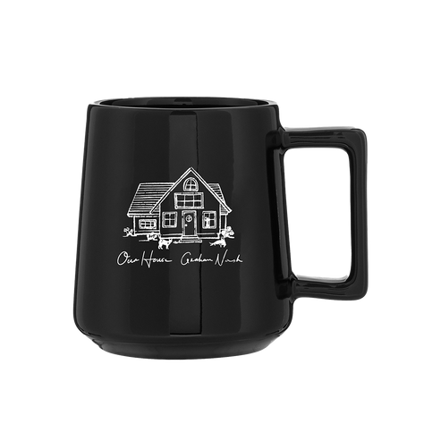 Black mug with a white house illustration and text on a white background
